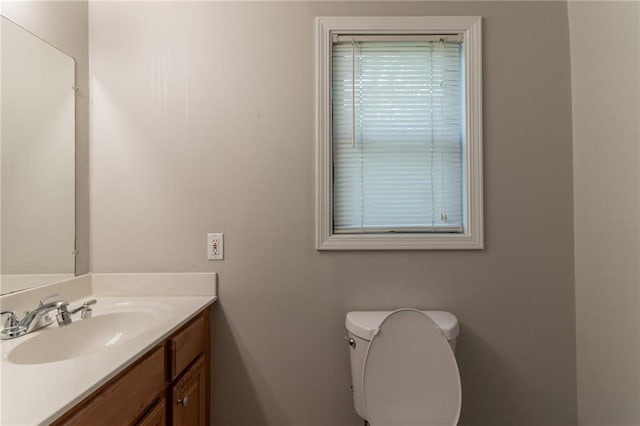 bathroom featuring toilet and vanity