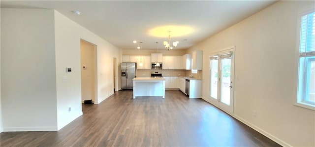 133 Wayside Ter, Braselton, GA 30517 - kitchen featuring stainless steel appliances, a chandelier, dark wood-style floors, a center island, and white cabinetry