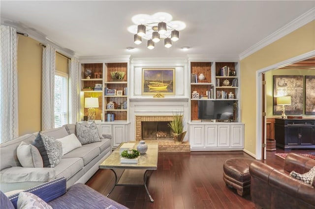living room featuring crown molding, dark wood-style flooring, a fireplace, a chandelier, and built in features