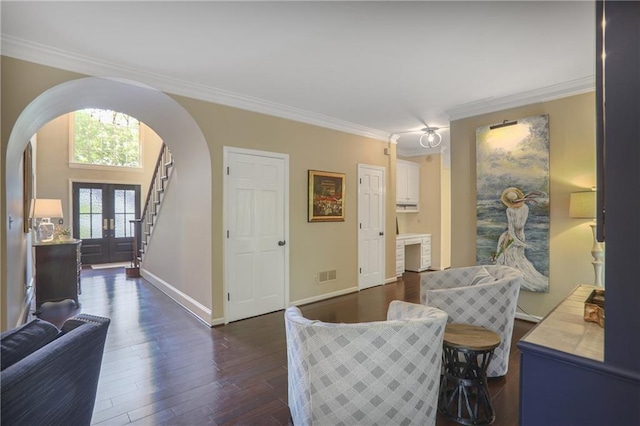 living area with arched walkways, crown molding, dark wood-style floors, baseboards, and french doors