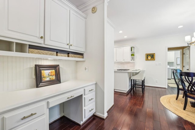 office space with crown molding, dark wood-type flooring, recessed lighting, and baseboards
