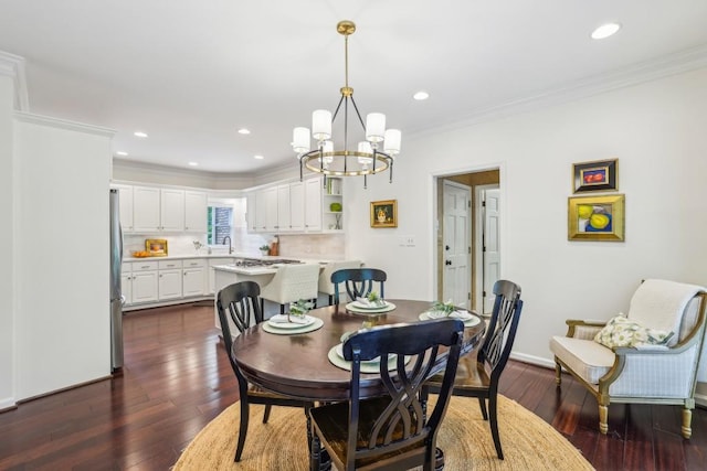 dining room with ornamental molding, dark wood-type flooring, a chandelier, and recessed lighting