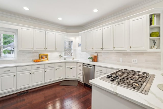 kitchen with appliances with stainless steel finishes, white cabinets, a sink, dark wood finished floors, and open shelves