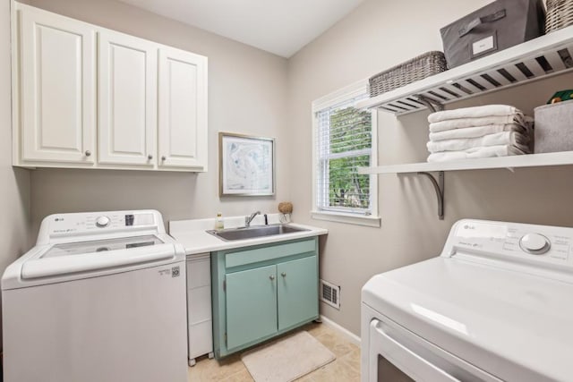 laundry area featuring cabinet space, independent washer and dryer, baseboards, and light tile patterned flooring