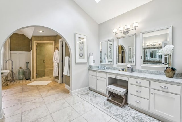 bathroom featuring lofted ceiling, a shower stall, vanity, and tile patterned flooring