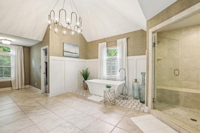 full bathroom featuring lofted ceiling, a decorative wall, a stall shower, healthy amount of natural light, and a soaking tub