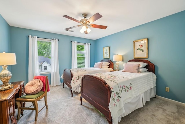 bedroom with light carpet, baseboards, and ceiling fan