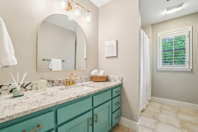 bathroom with baseboards, vanity, and tile patterned flooring