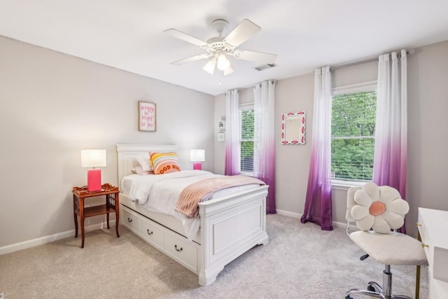 bedroom with light colored carpet, baseboards, and ceiling fan