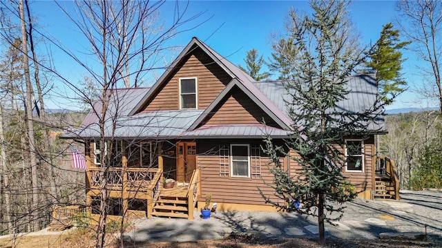 view of front of home featuring metal roof and a porch