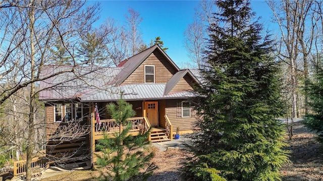 chalet / cabin with covered porch and metal roof