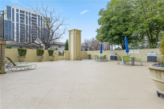 surrounding community with fence, outdoor dining area, and a patio area