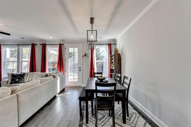 dining room featuring wood-type flooring and crown molding