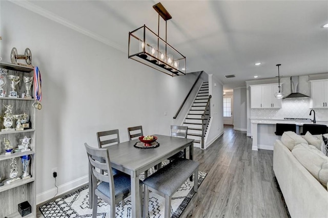 dining area with ornamental molding and hardwood / wood-style floors