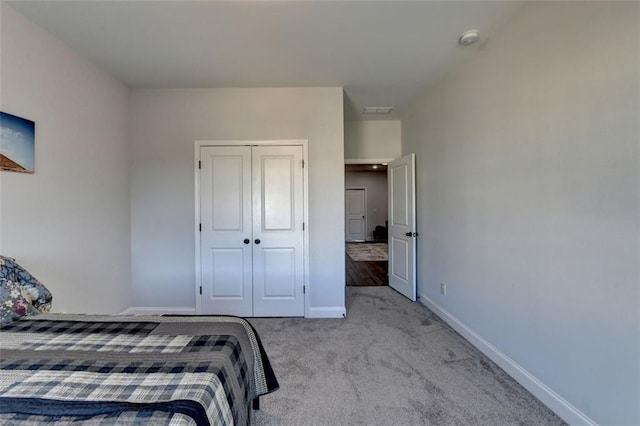 bedroom with light carpet and a closet