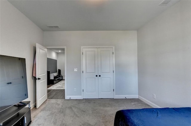 carpeted bedroom featuring a closet