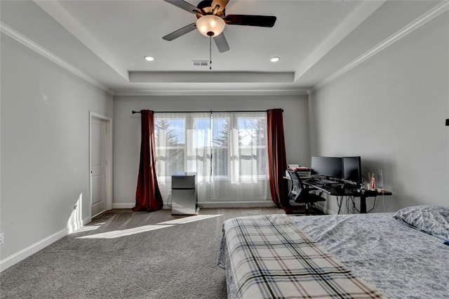 carpeted bedroom with ornamental molding, a raised ceiling, and ceiling fan