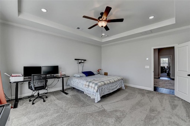 bedroom with a raised ceiling, ornamental molding, carpet flooring, and ceiling fan