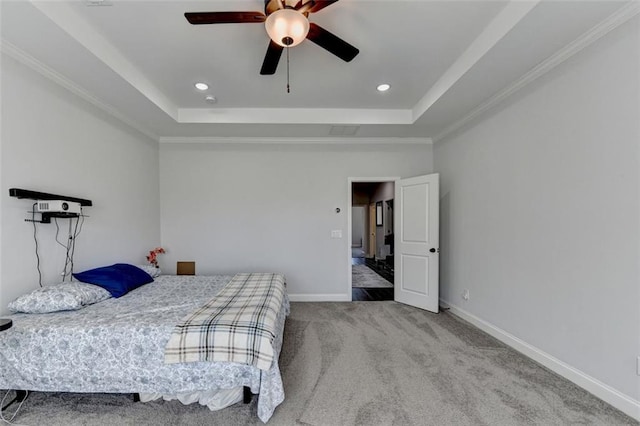 bedroom featuring a raised ceiling, ornamental molding, carpet flooring, and ceiling fan