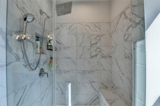 bathroom with tiled shower