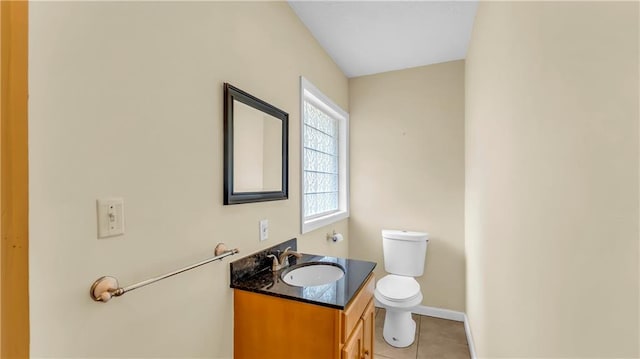 bathroom with tile patterned flooring, vanity, and toilet