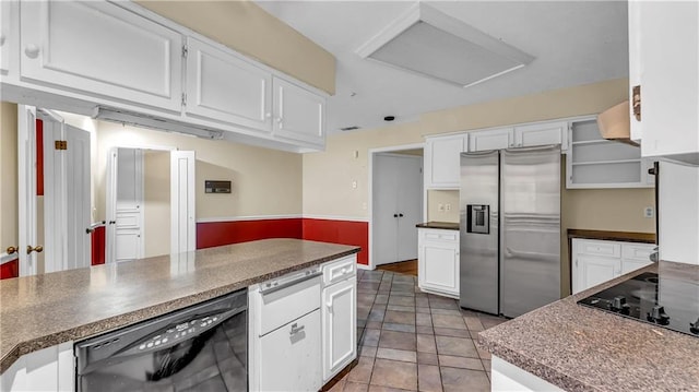 kitchen with light tile patterned floors, white cabinetry, and black appliances