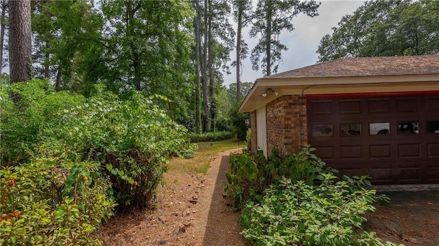 view of side of home with an outdoor structure and a garage