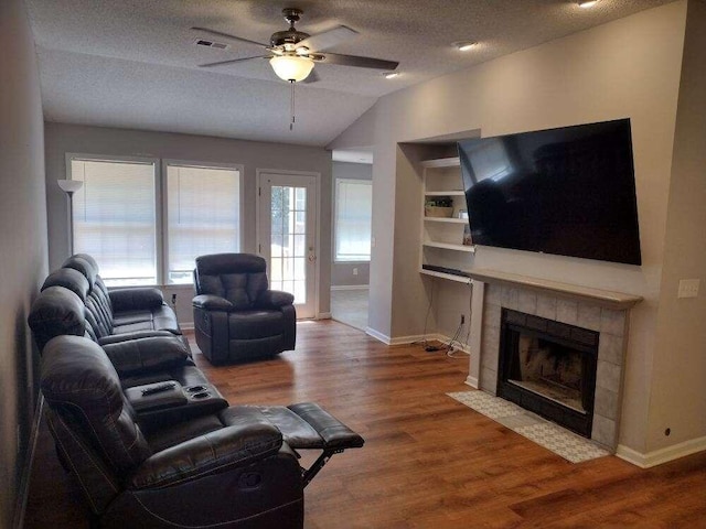 living room featuring visible vents, ceiling fan, vaulted ceiling, and baseboards