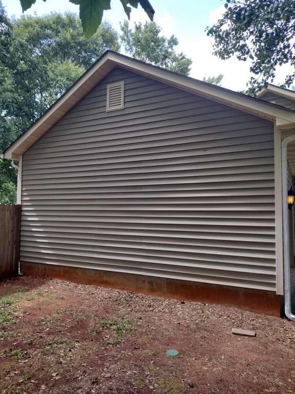 view of property exterior featuring fence