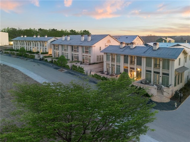 view of back house at dusk