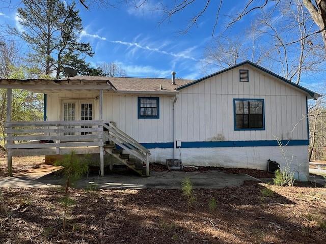 506 Carlton Dr, Palmetto, GA 30268 - view of front of house featuring a wooden deck and a patio area
