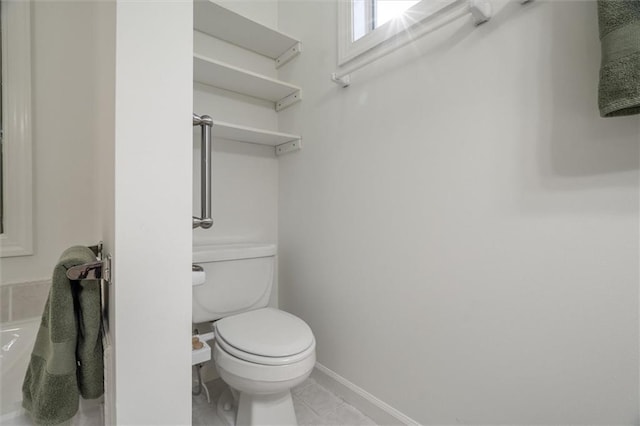 bathroom with tile patterned floors and toilet