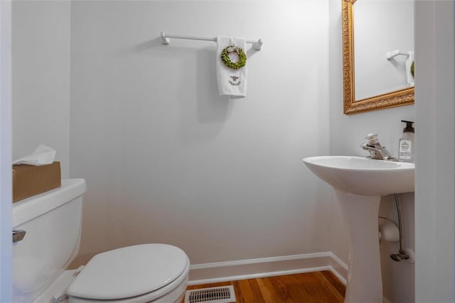 bathroom featuring toilet and hardwood / wood-style flooring