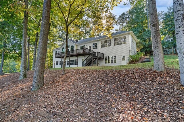 back of house featuring a deck