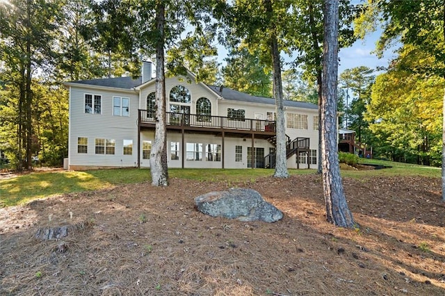 rear view of house featuring a deck