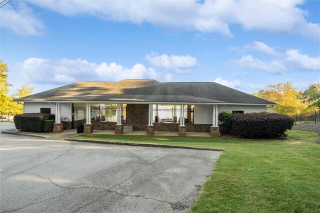 view of front of home with a front yard and a porch