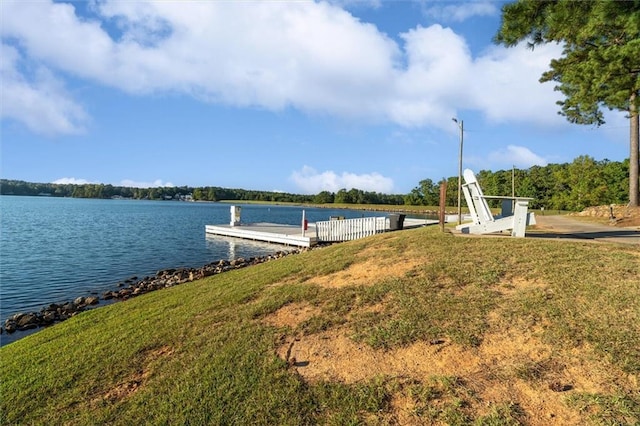 view of dock featuring a yard and a water view