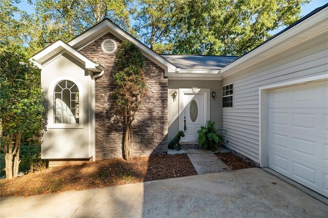 doorway to property featuring a garage