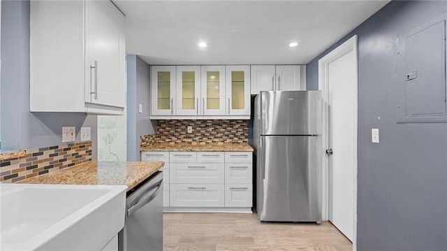 47 Arbor End, Smyrna, GA 30080 - kitchen with stainless steel appliances, white cabinetry, light wood-type flooring, electric panel, and recessed lighting