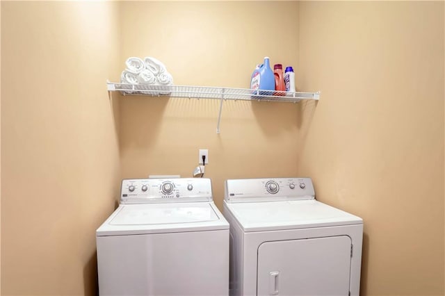 clothes washing area featuring washer and dryer