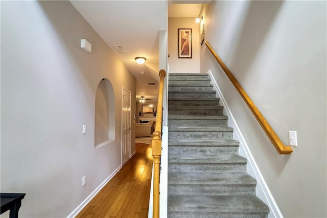 stairs with hardwood / wood-style floors