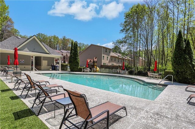 view of swimming pool with a patio area