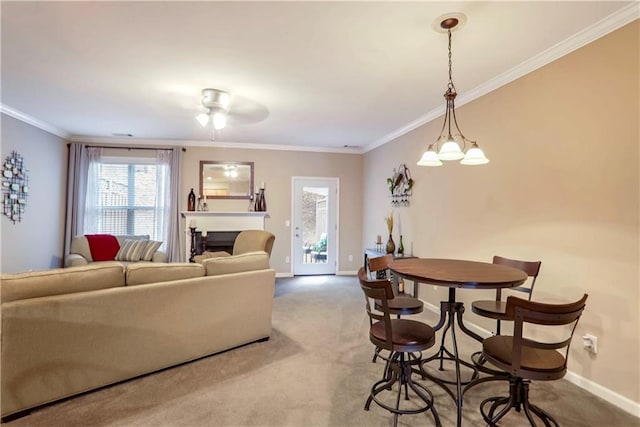 living room with carpet, ceiling fan with notable chandelier, and ornamental molding