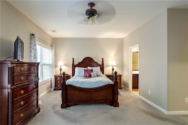 carpeted bedroom featuring ensuite bath and ceiling fan