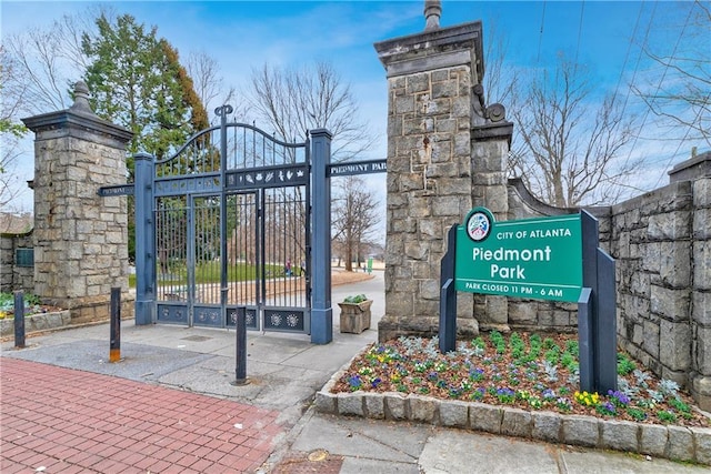 view of home's community with a gate and fence