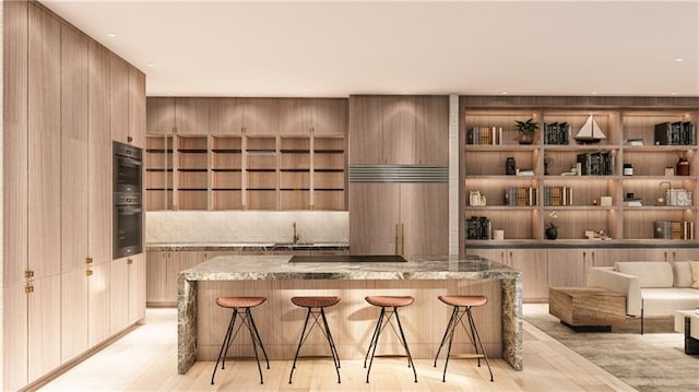 interior space with tasteful backsplash, light wood-style flooring, double wall oven, black electric cooktop, and paneled refrigerator