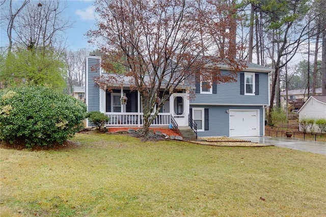 split level home featuring a front lawn, a porch, concrete driveway, a chimney, and an attached garage