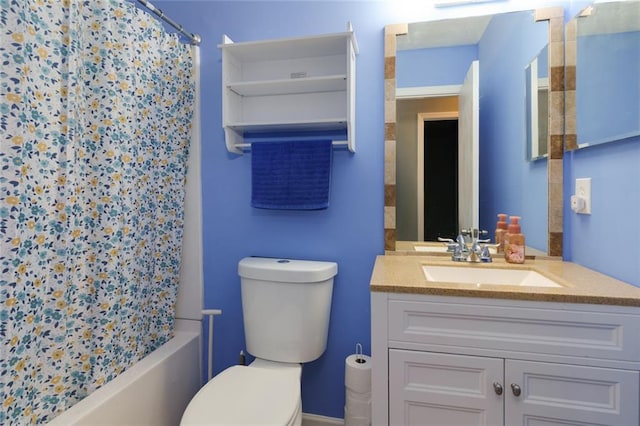 bathroom featuring vanity, toilet, and shower / bath combo with shower curtain