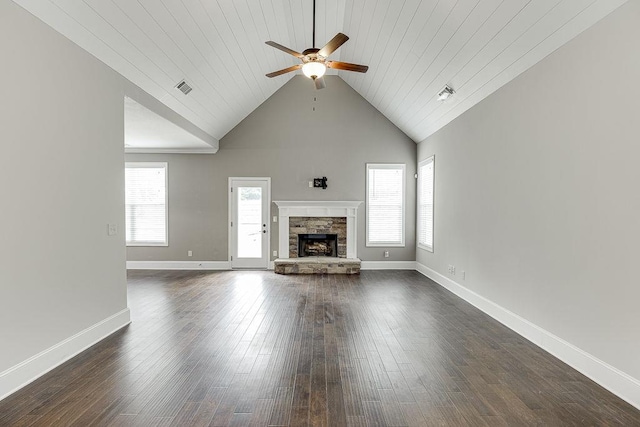 63 Emma Ln, Winder, GA 30680 - unfurnished living room featuring a ceiling fan, a stone fireplace, dark wood-type flooring, wood ceiling, and baseboards