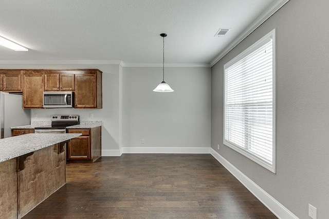 63 Emma Ln, Winder, GA 30680 - kitchen with stainless steel appliances, dark wood finished floors, hanging light fixtures, plenty of natural light, and ornamental molding